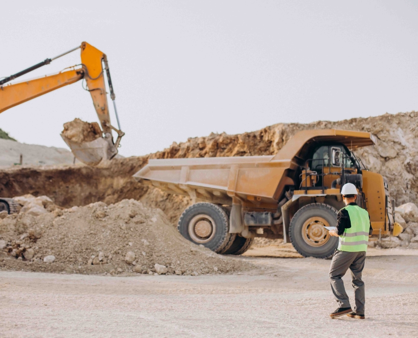 Male worker with bulldozer in sand quarry