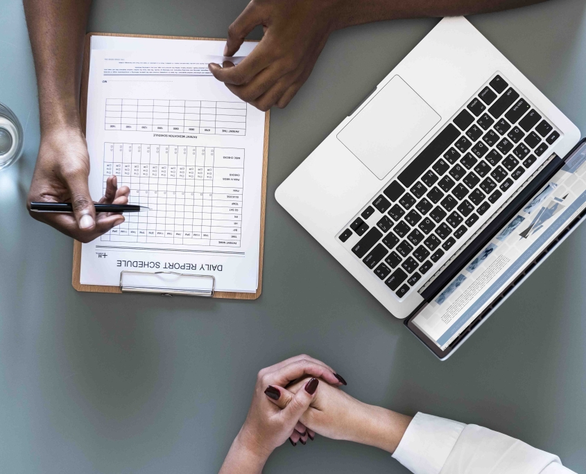Aerial view of doctor writing patient daily report checklist